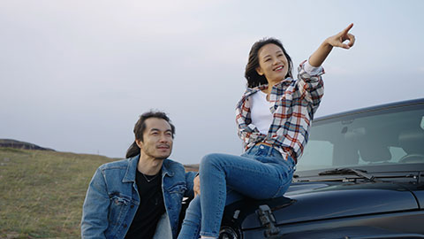 Happy Chinese couple enjoying road trip,4K