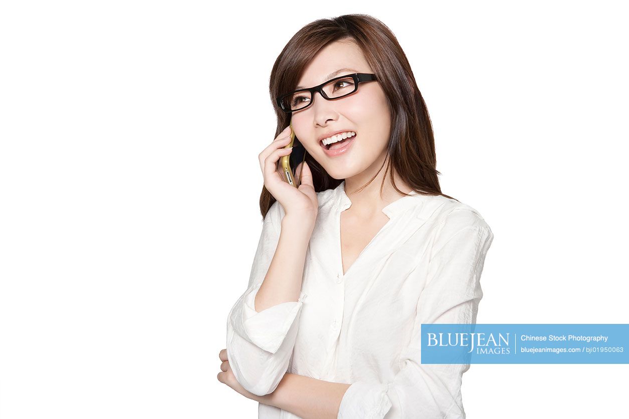 Portrait of young Chinese woman on mobile phone