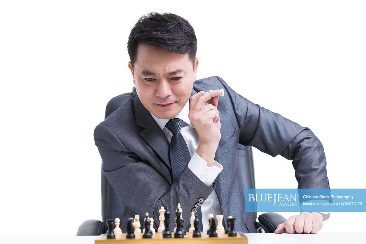 Chinese businessman playing chess