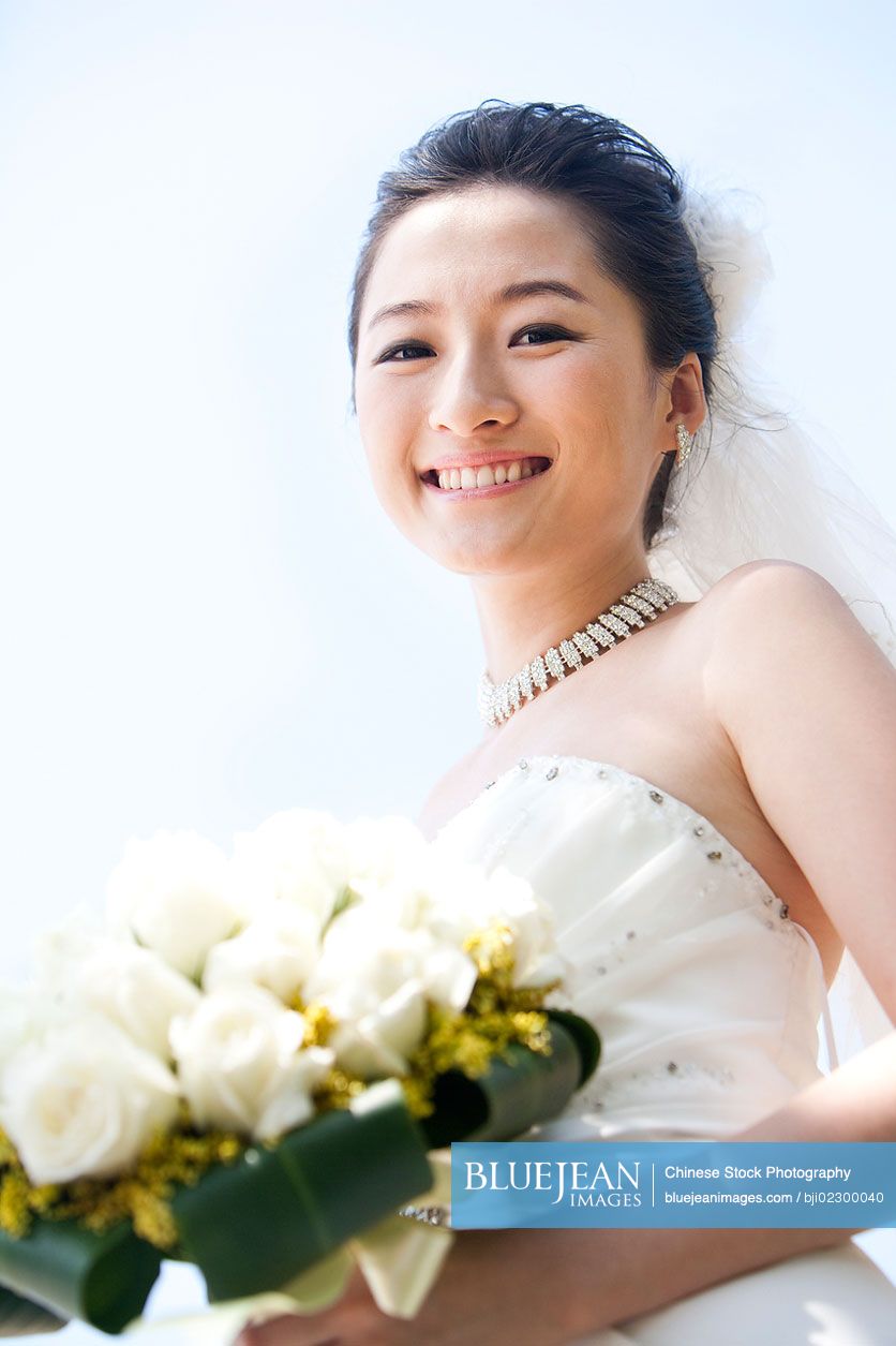 Portrait of happy Chinese bride