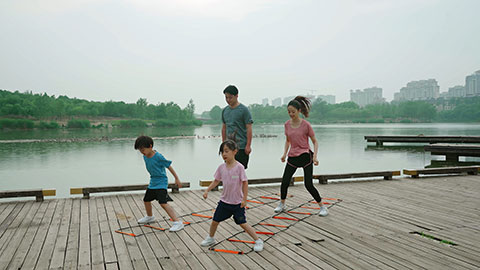 A young family works out in the park, staying active and healthy