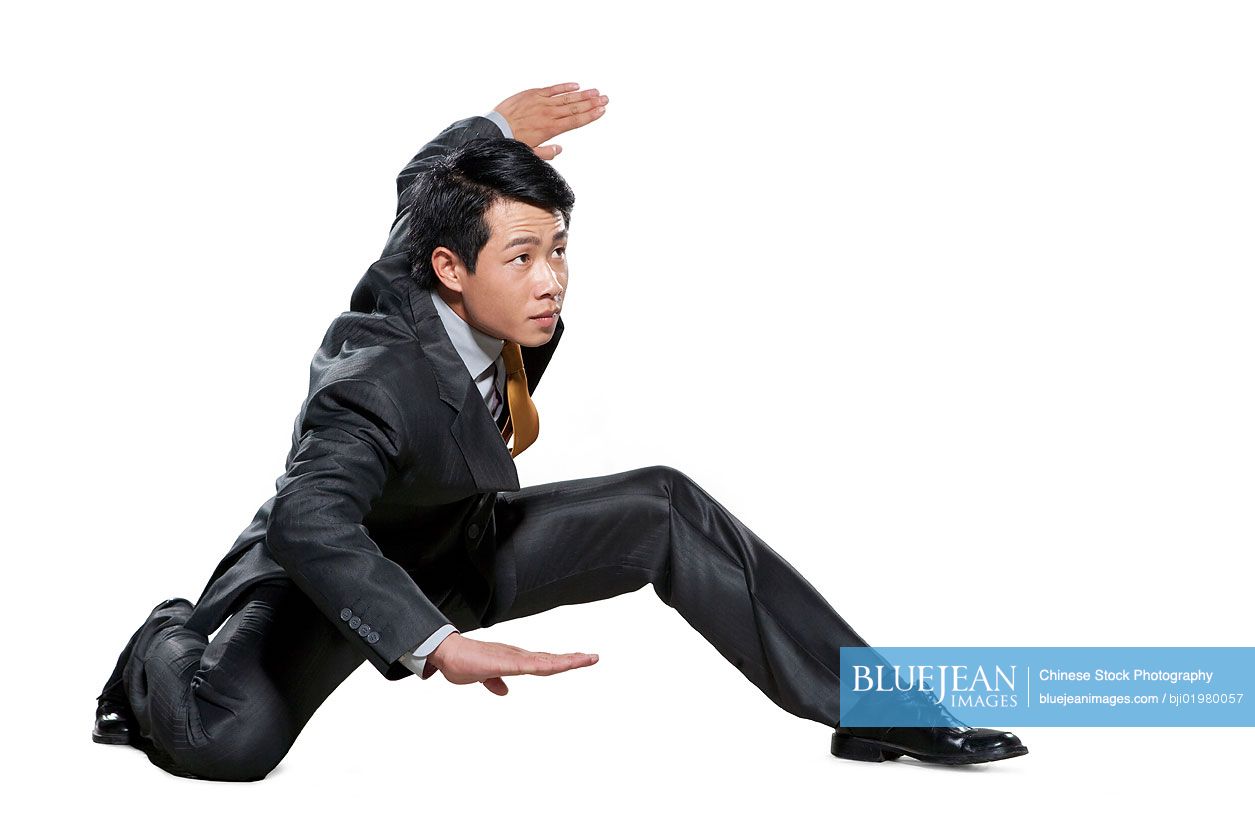 Chinese businessman in martial arts crouching stance