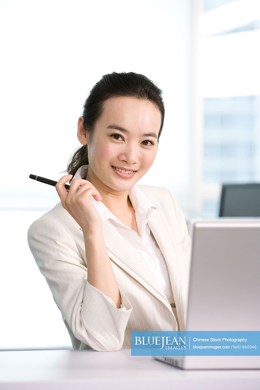 Chinese office worker at her desk
