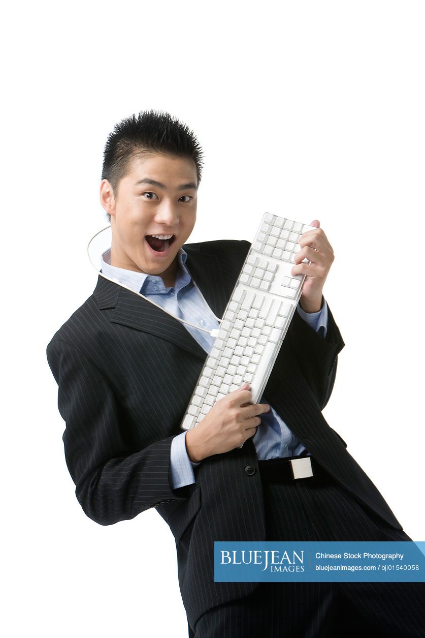 Chinese businessman playing keyboard