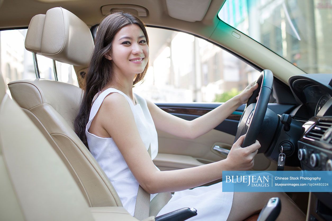 Young Chinese woman driving car
