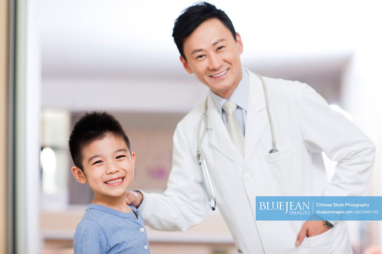 Happy Chinese doctor with cute boy