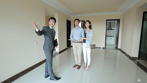 Young Chinese realtor showing new house to young couple,HD