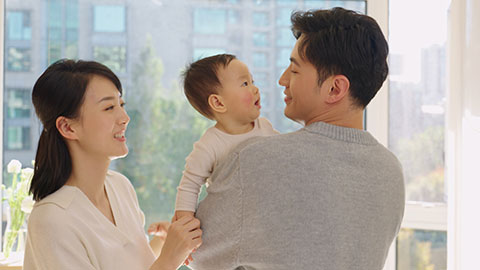 Young Chinese parents spending time with their baby