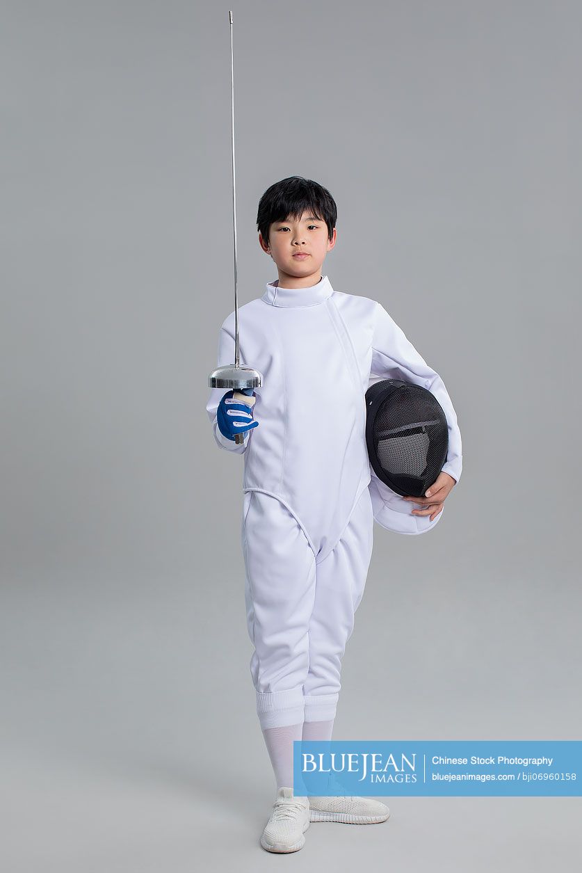 Cute Chinese boy in fencing suit