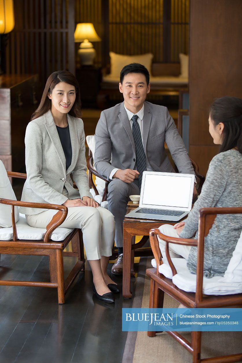 Confident Chinese business people and a mature woman