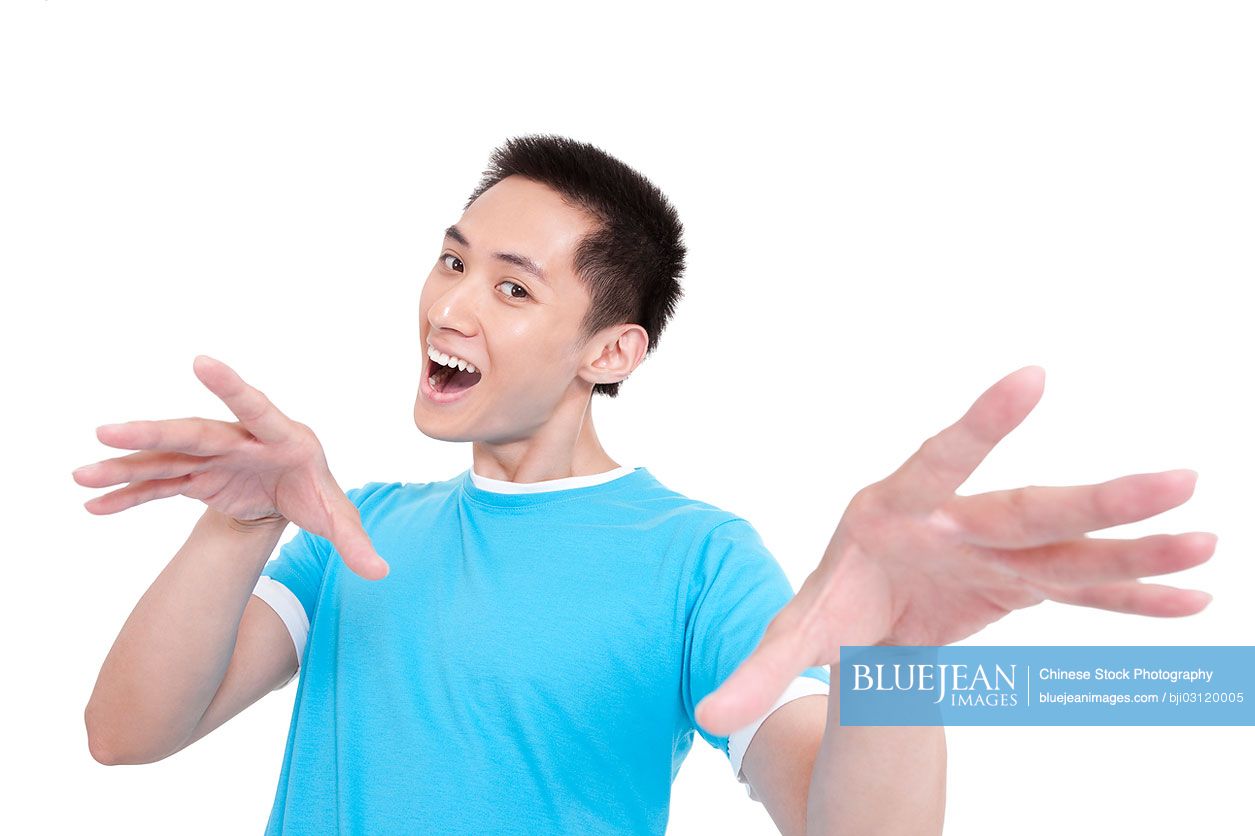 Excited young Chinese man gesturing with hands