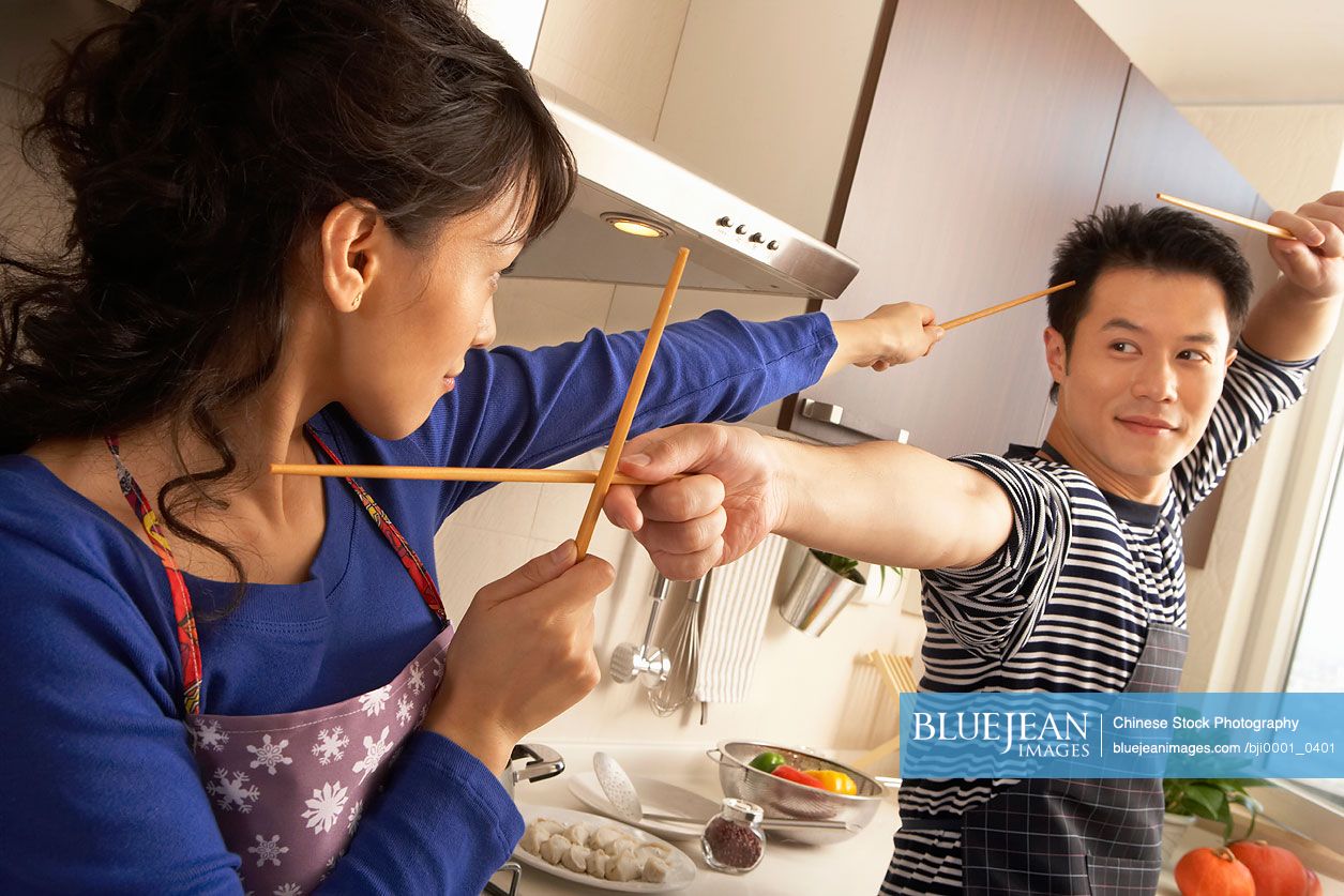 Young Chinese Couple Have A Sword Fight With Chop Sticks