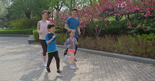 Happy young Chinese family running in park,4K