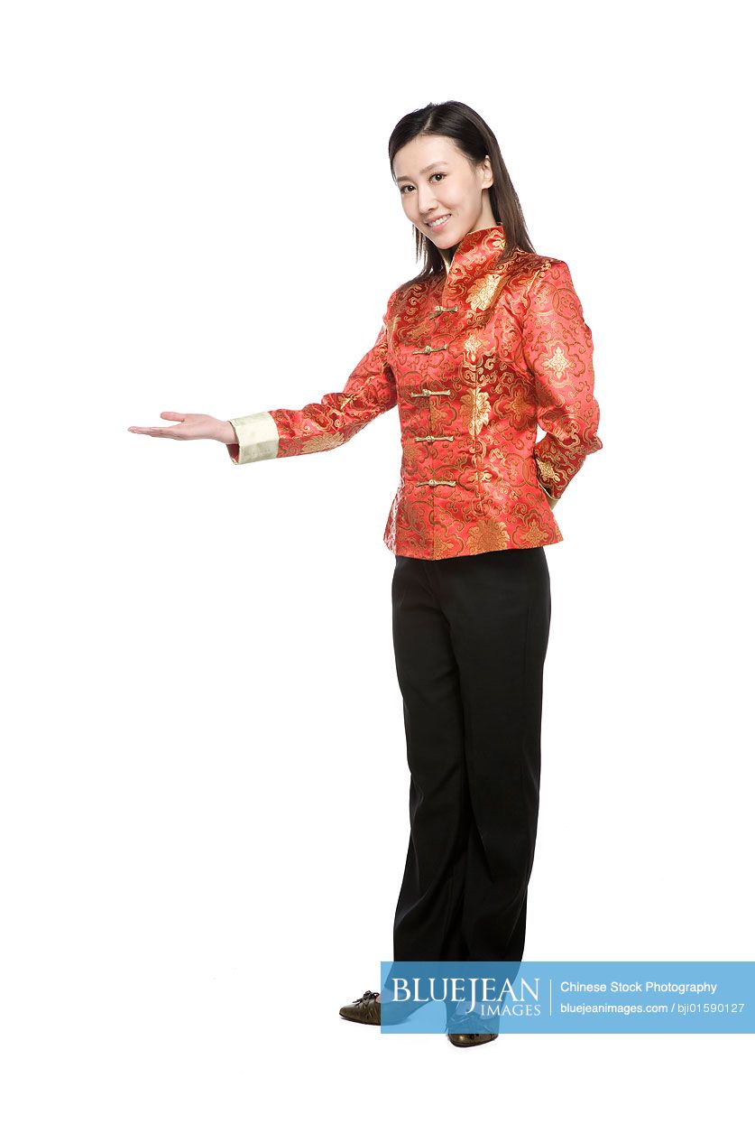 Young woman in Chinese traditional clothes doing welcoming gesture