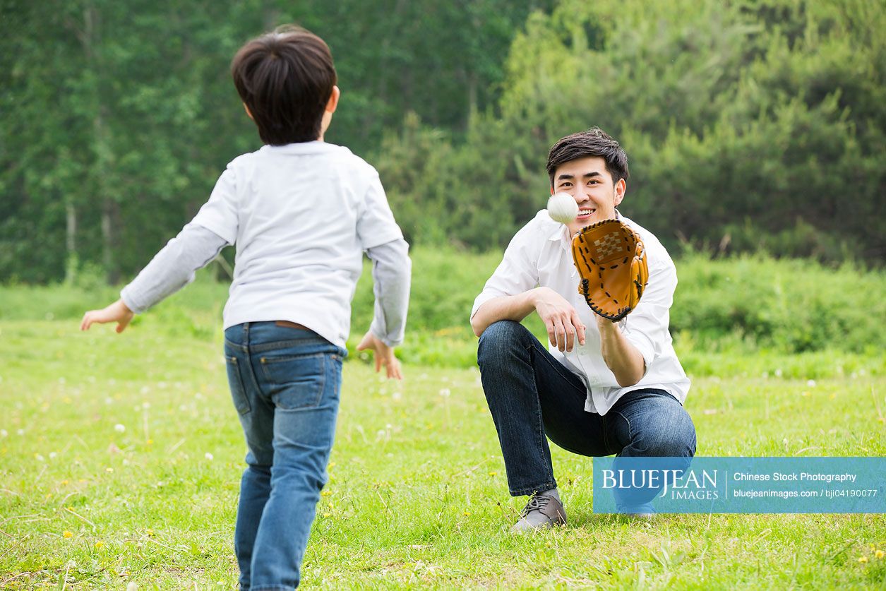 Chinese father and son playing baseball