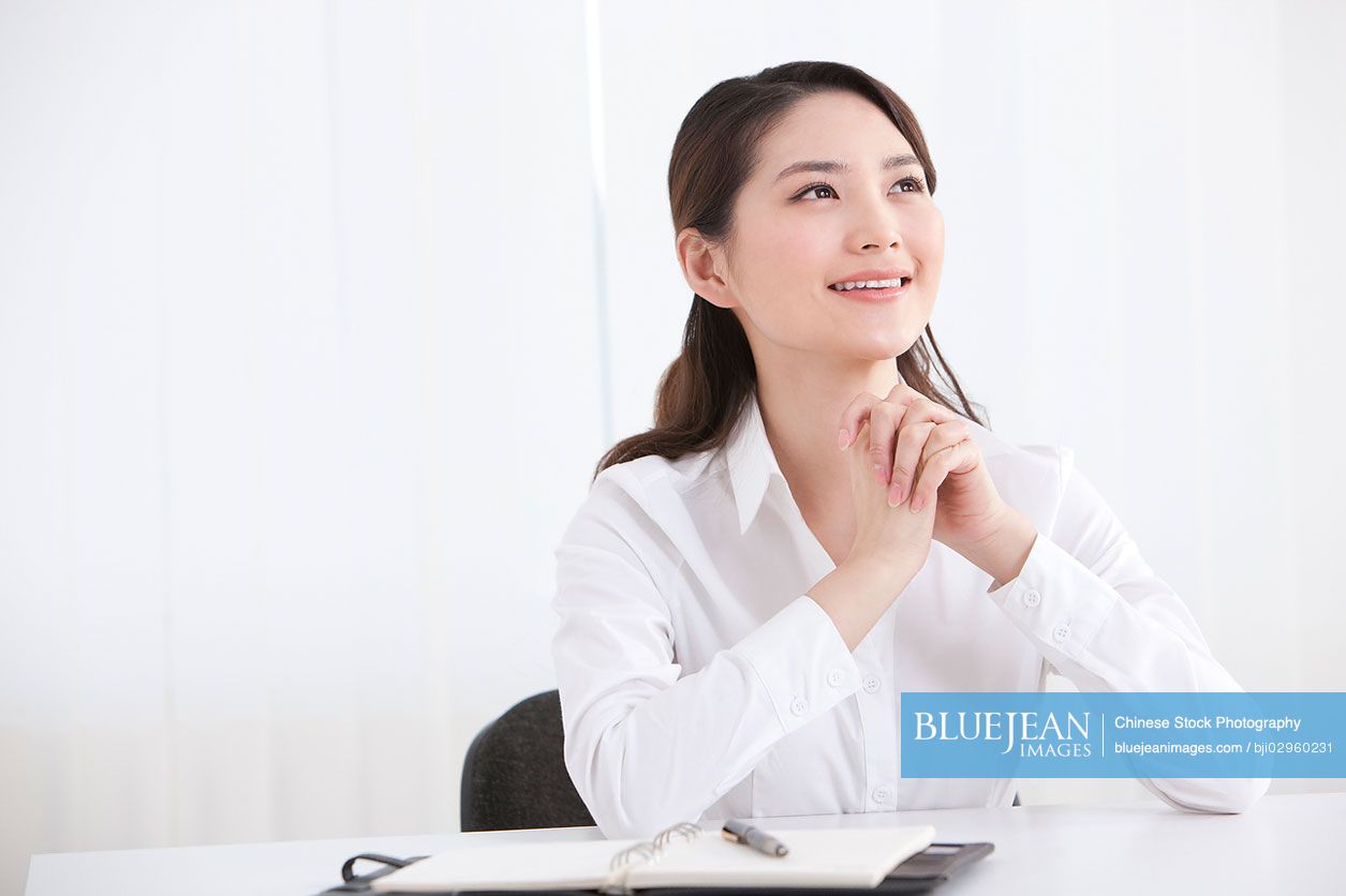 Young Chinese businesswoman in office