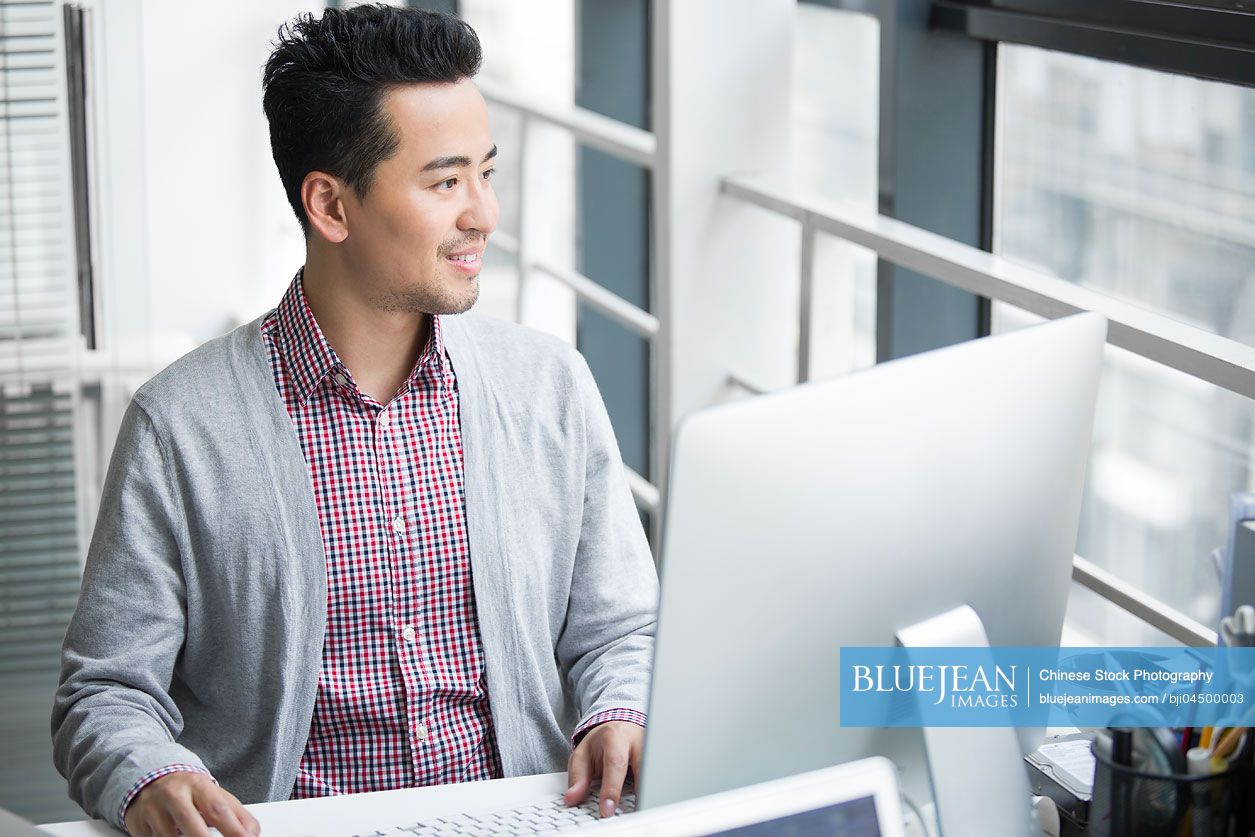 Chinese businessman working in office with computer