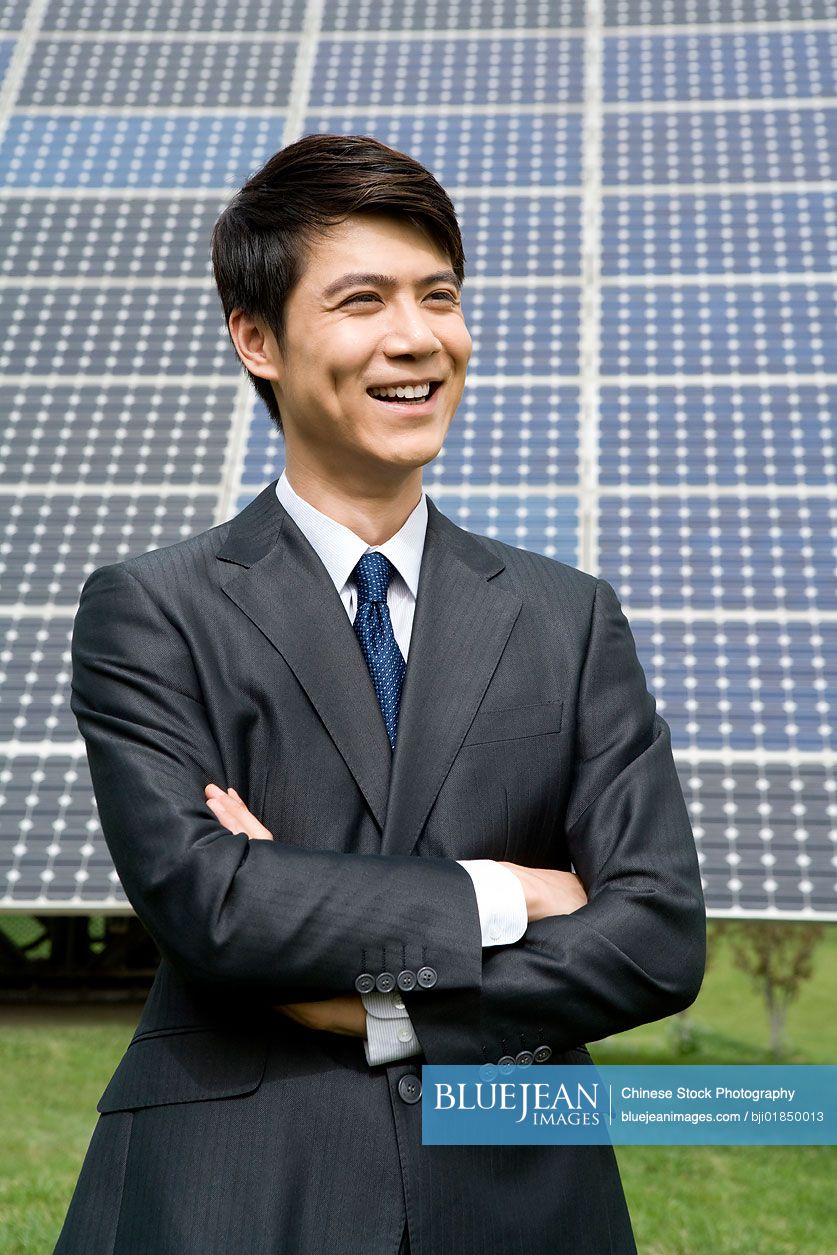 Portrait of a Chinese businessman in front of solar panels
