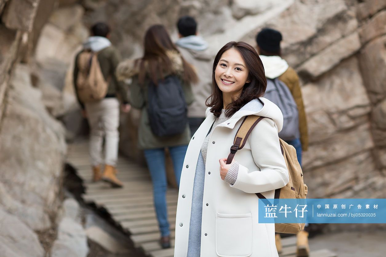 Portrait of cheerful young Chinese woman outdoors in winter