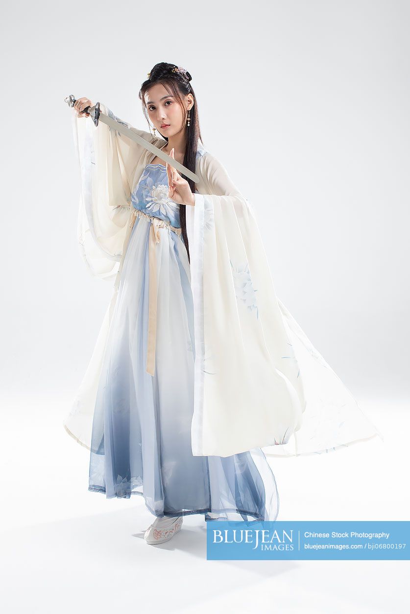 Young Chinese woman in ancient costume holding a sword