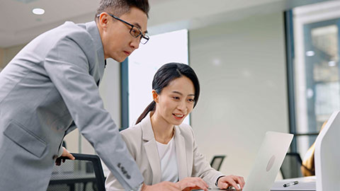 Confident Chinese business people talking in office