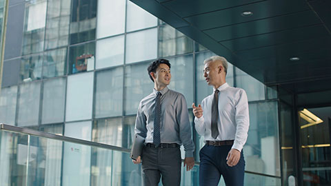 Confident Chinese business people walking in office building,4K