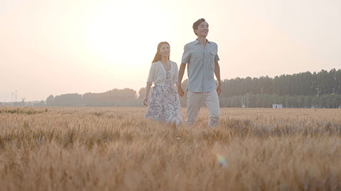 Happy young Chinese couple having fun in wheat field,HD