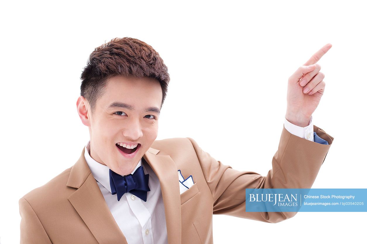 Stylish young Chinese businessman pointing