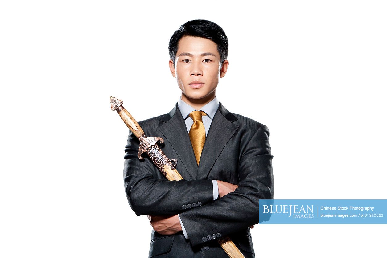 Chinese businessman holding a sword