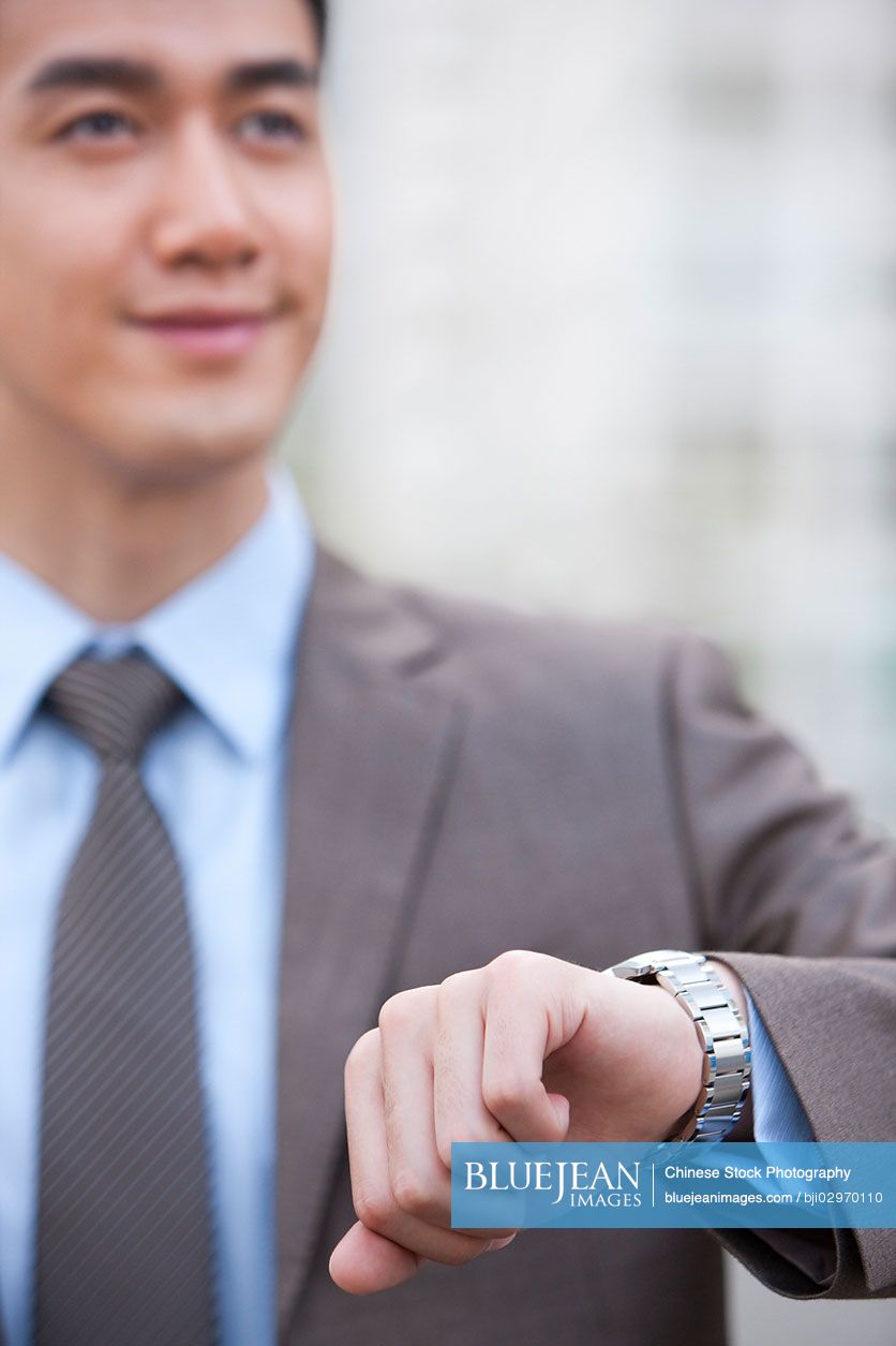 Young Chinese businessman in a hurry