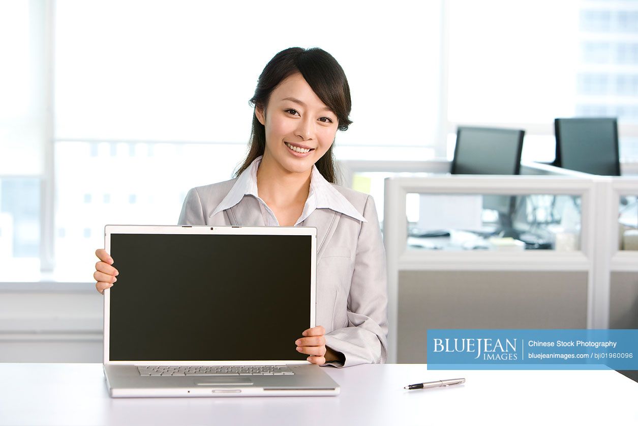 Chinese office worker at her desk