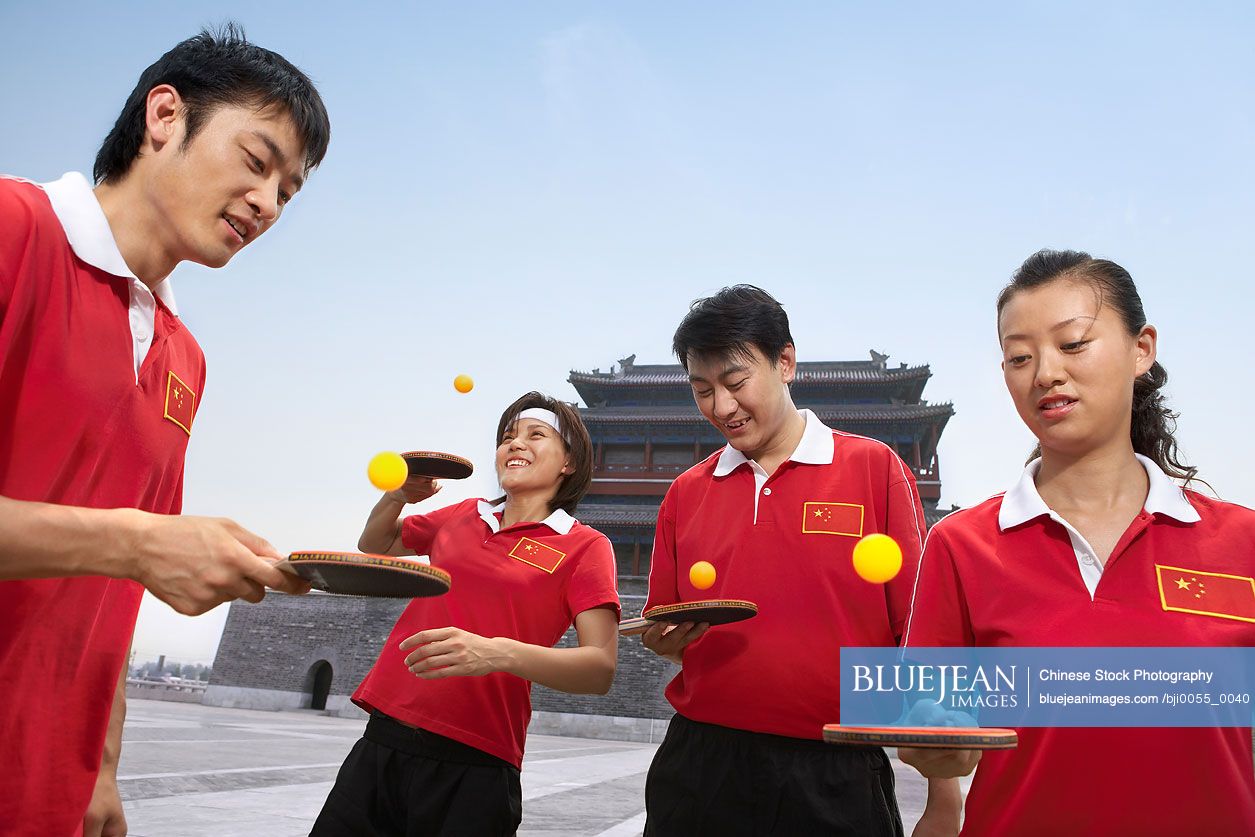 Chinese Ping Pong Players Bouncing Balls Off Their Bats