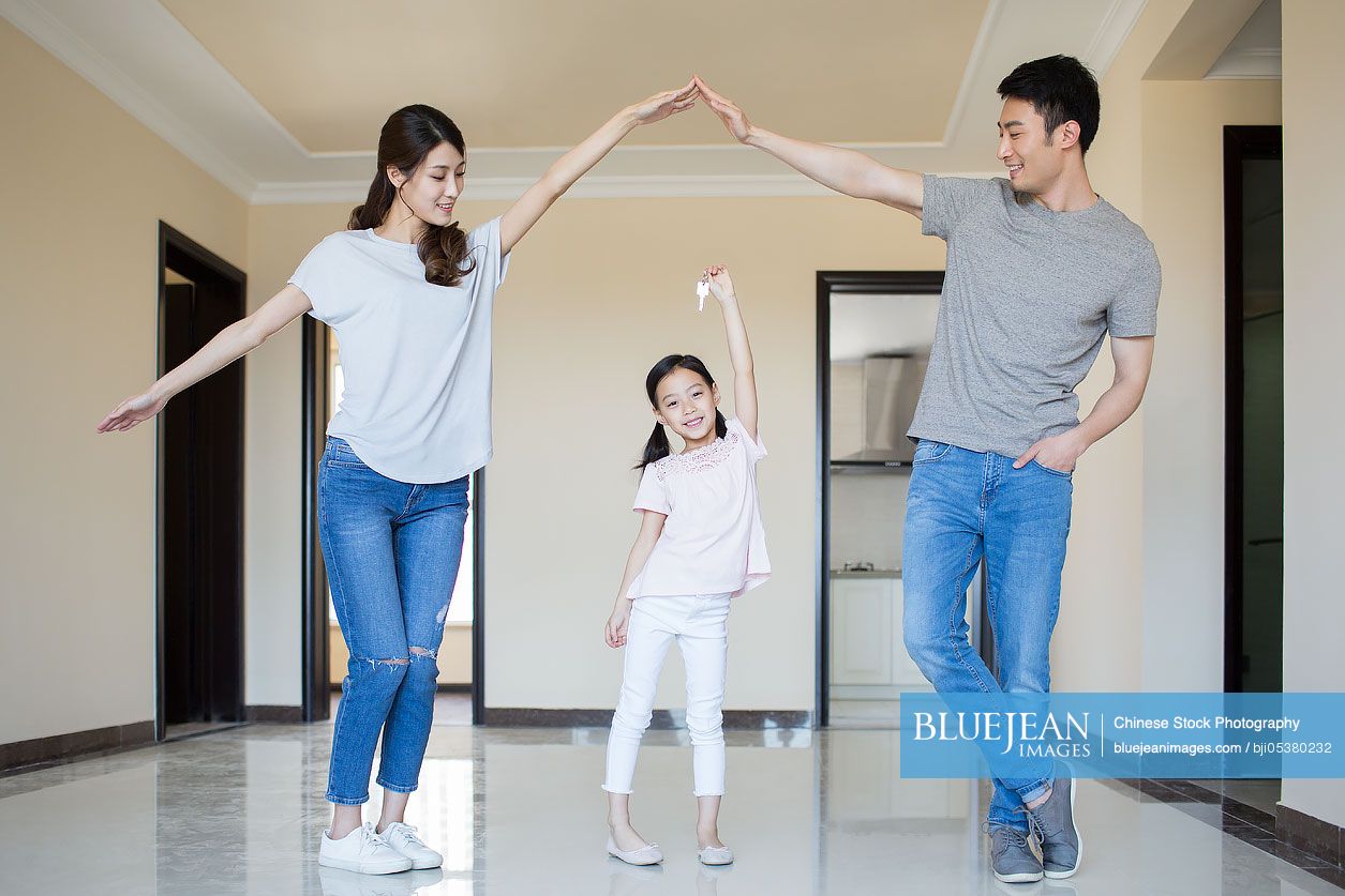 Happy Young Chinese Family Holding Keys In Their New House High res happy-young-chinese-family-holding-keys-in-their-new-house-high-res