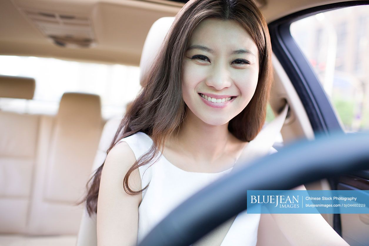 Young Chinese woman driving car