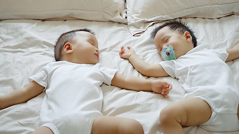 Two twin babies enjoying their midday nap