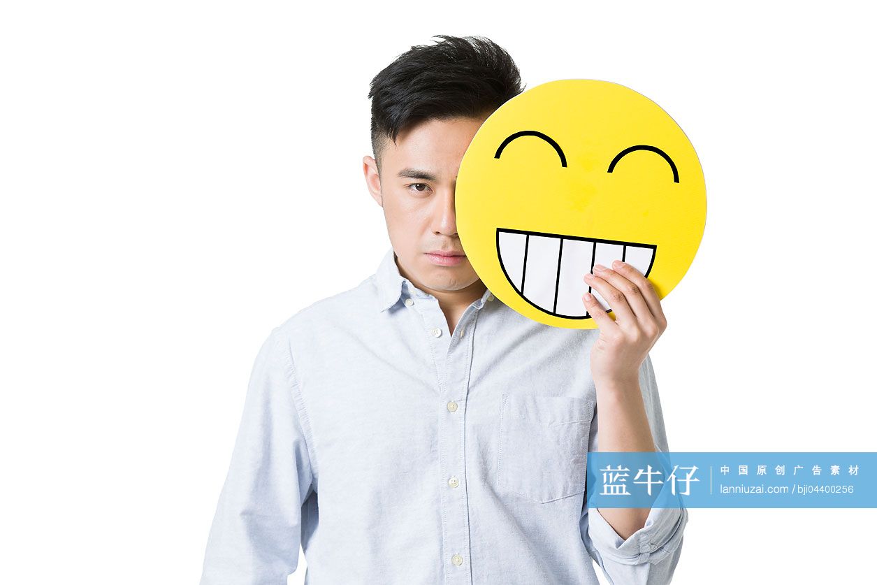 年轻男子拿着一张卡通笑脸-蓝牛仔影像-中国原创广告影像素材
