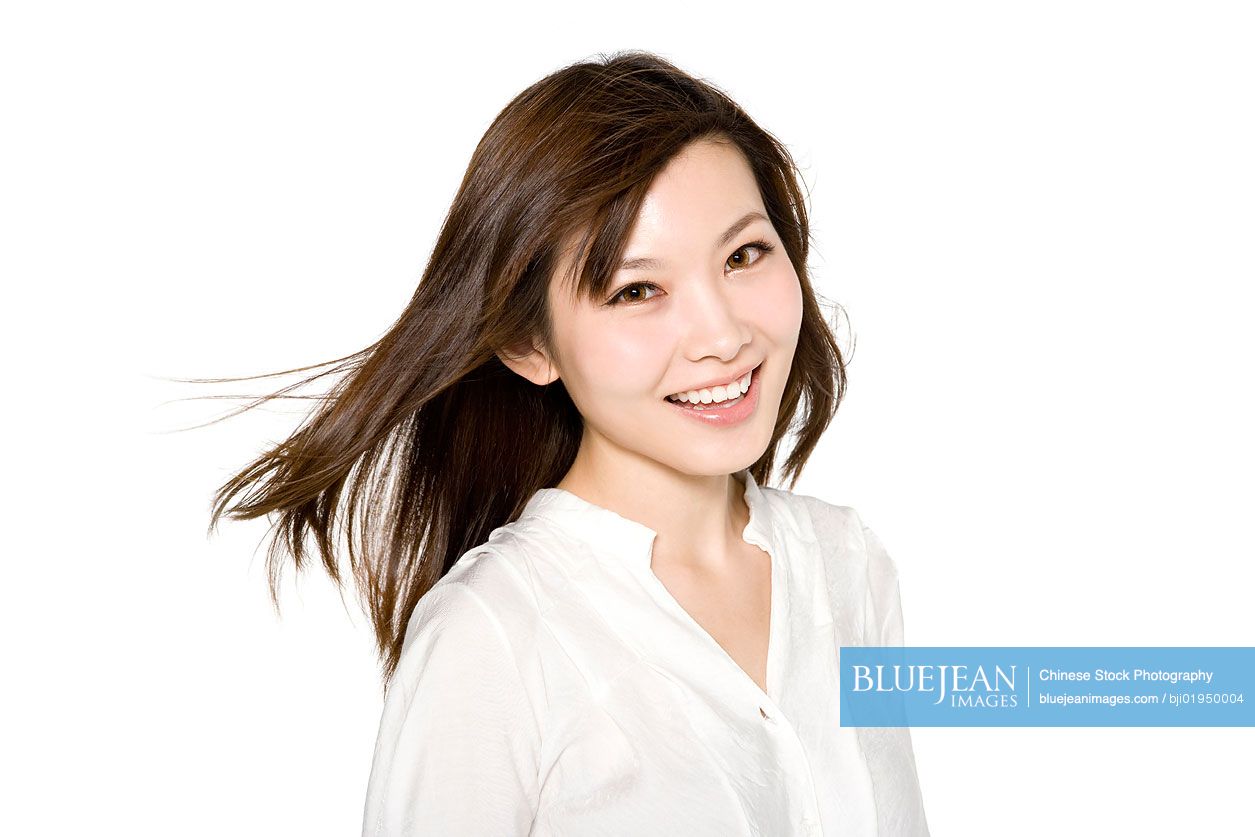 Portrait of young Chinese woman in white blouse