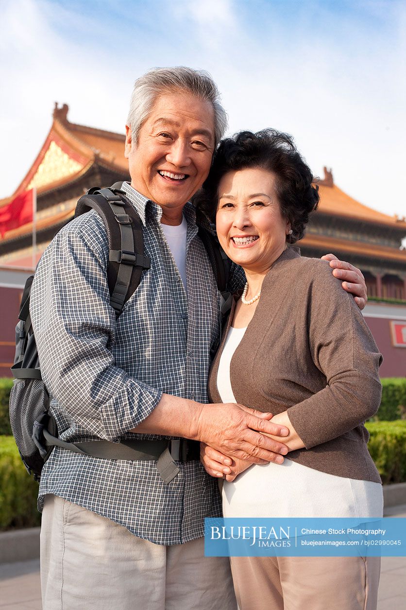 Senior Chinese couple travelling at Tiananmen Square in Beijing, China