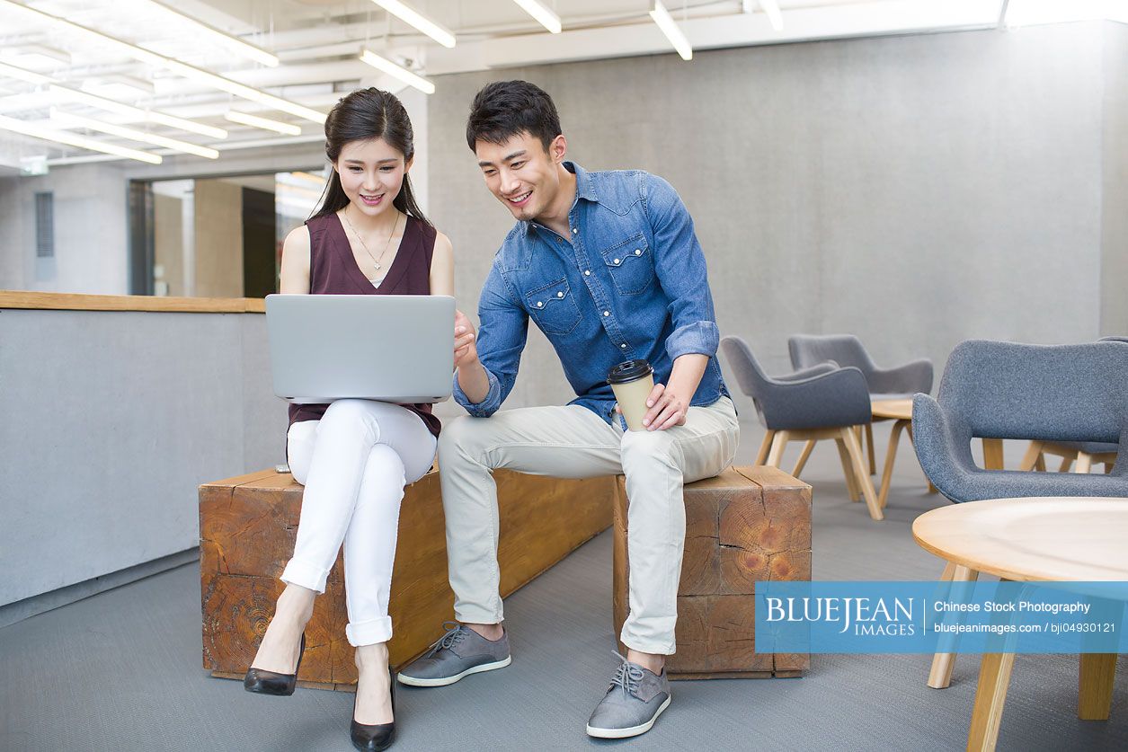 Chinese business people working with laptop in office
