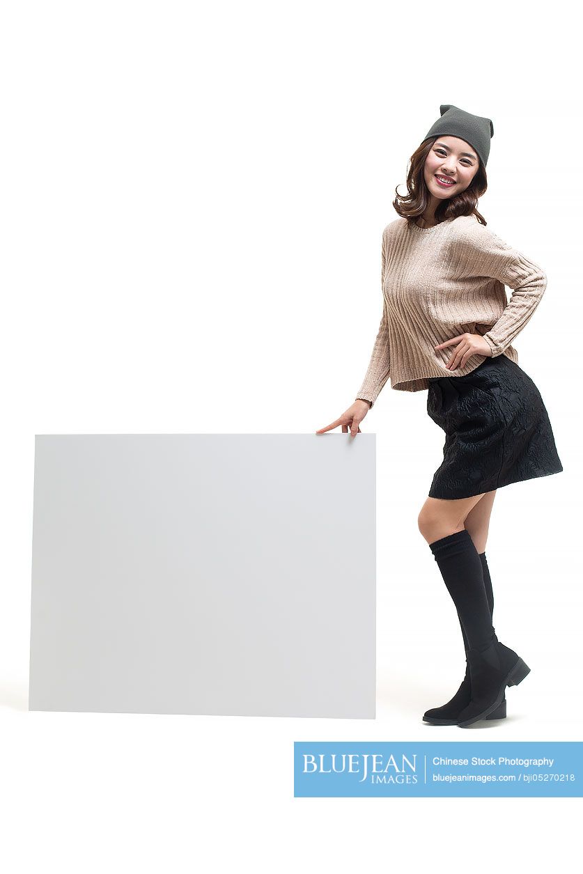 Young Chinese woman showing whiteboard