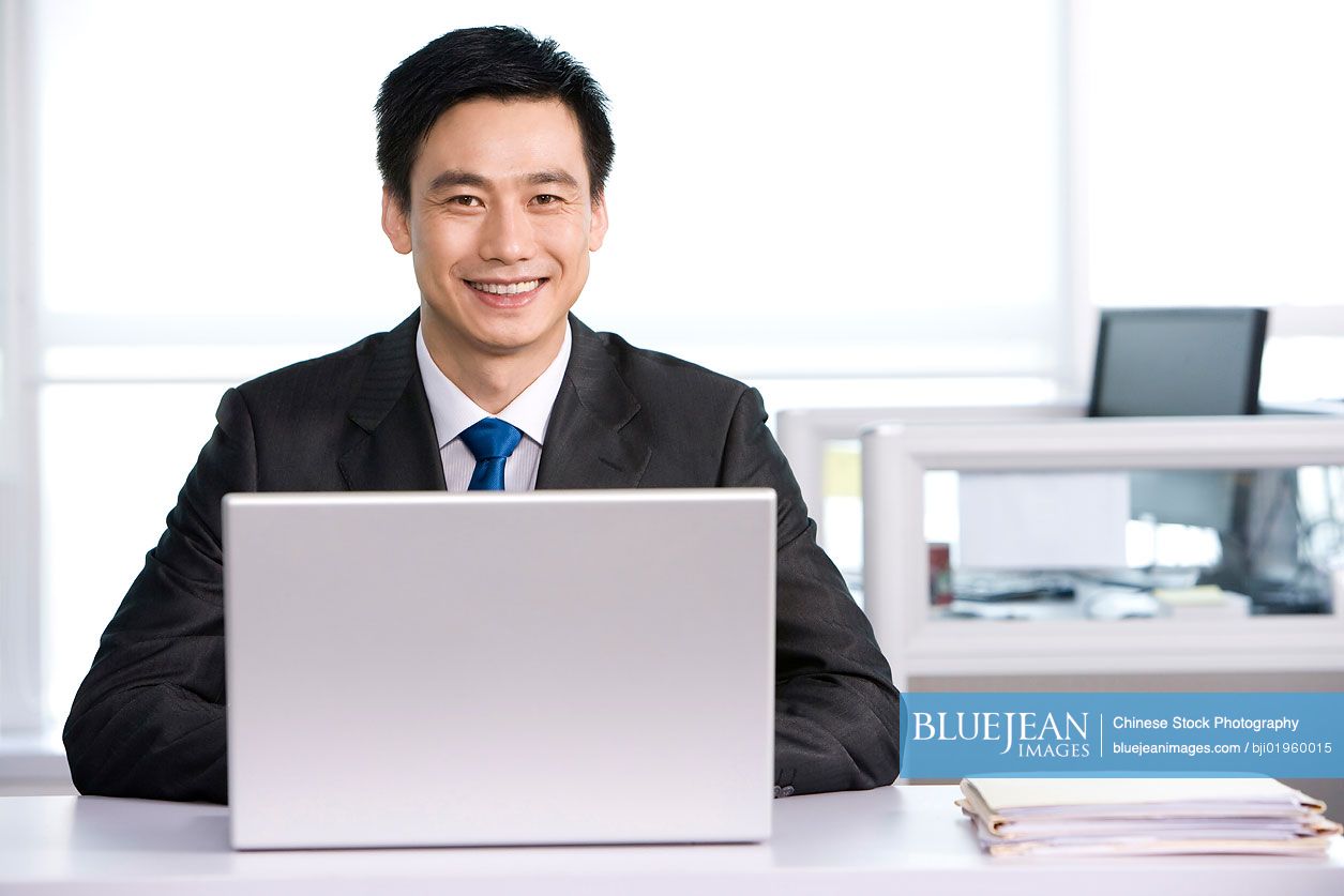 Chinese office worker at his desk