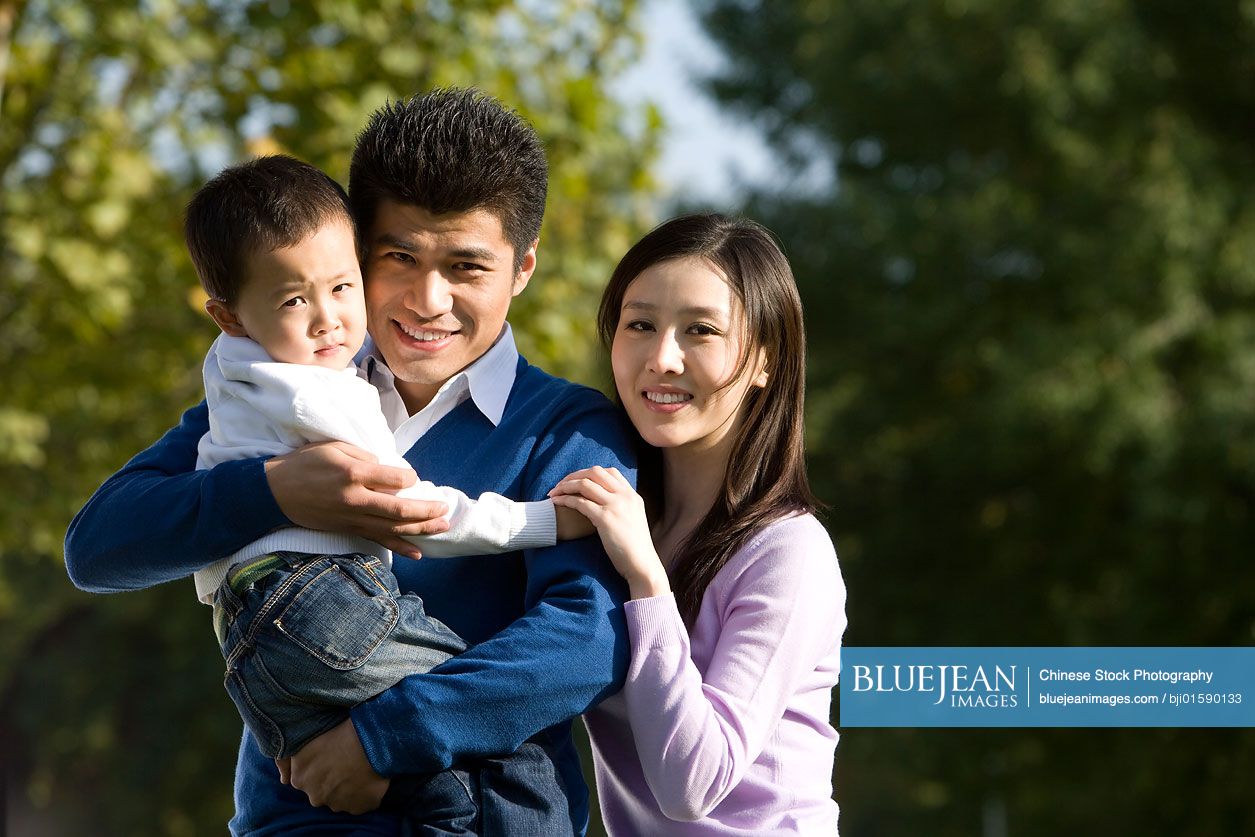 Portrait of young Chinese family at the park