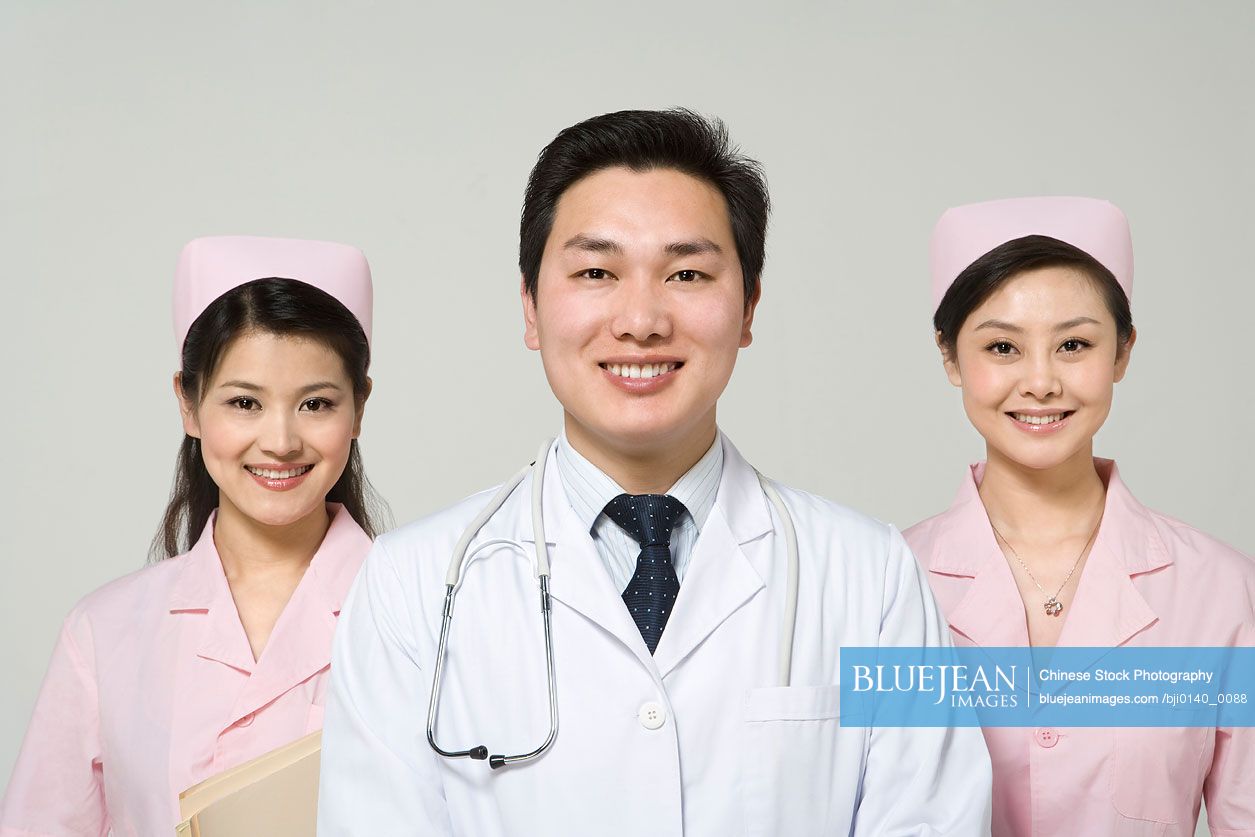 Chinese doctor with nurses in pink uniforms