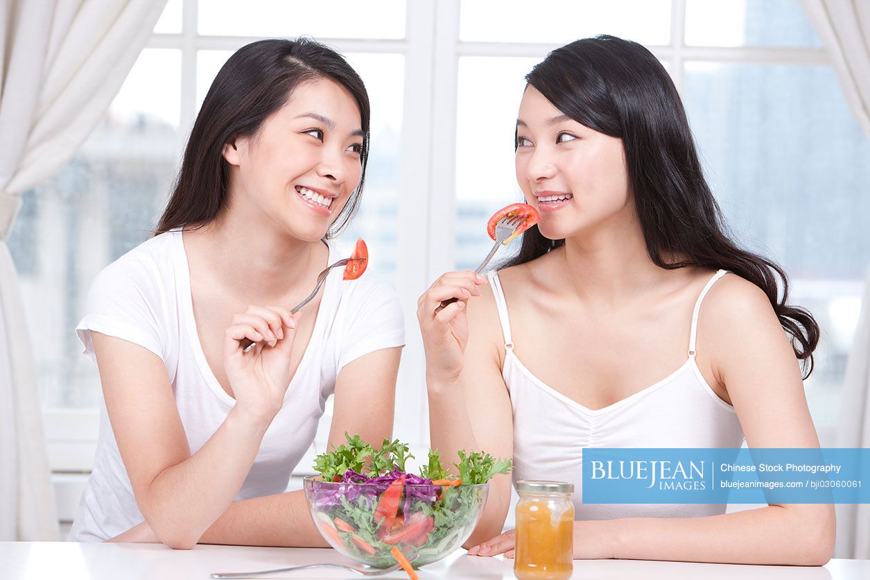 Best female Chinese friends sharing salad together