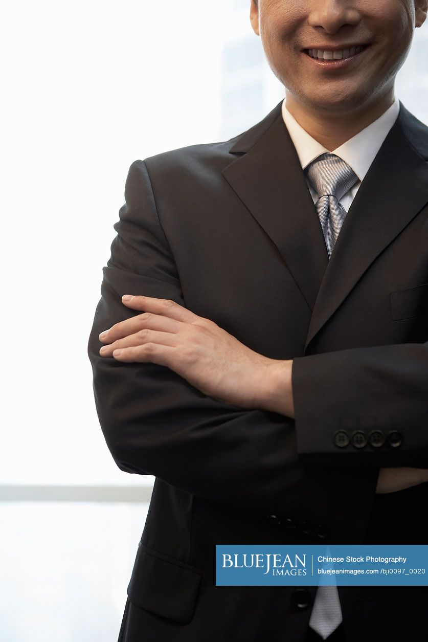 Chinese Businessman In Office With Arms Folded