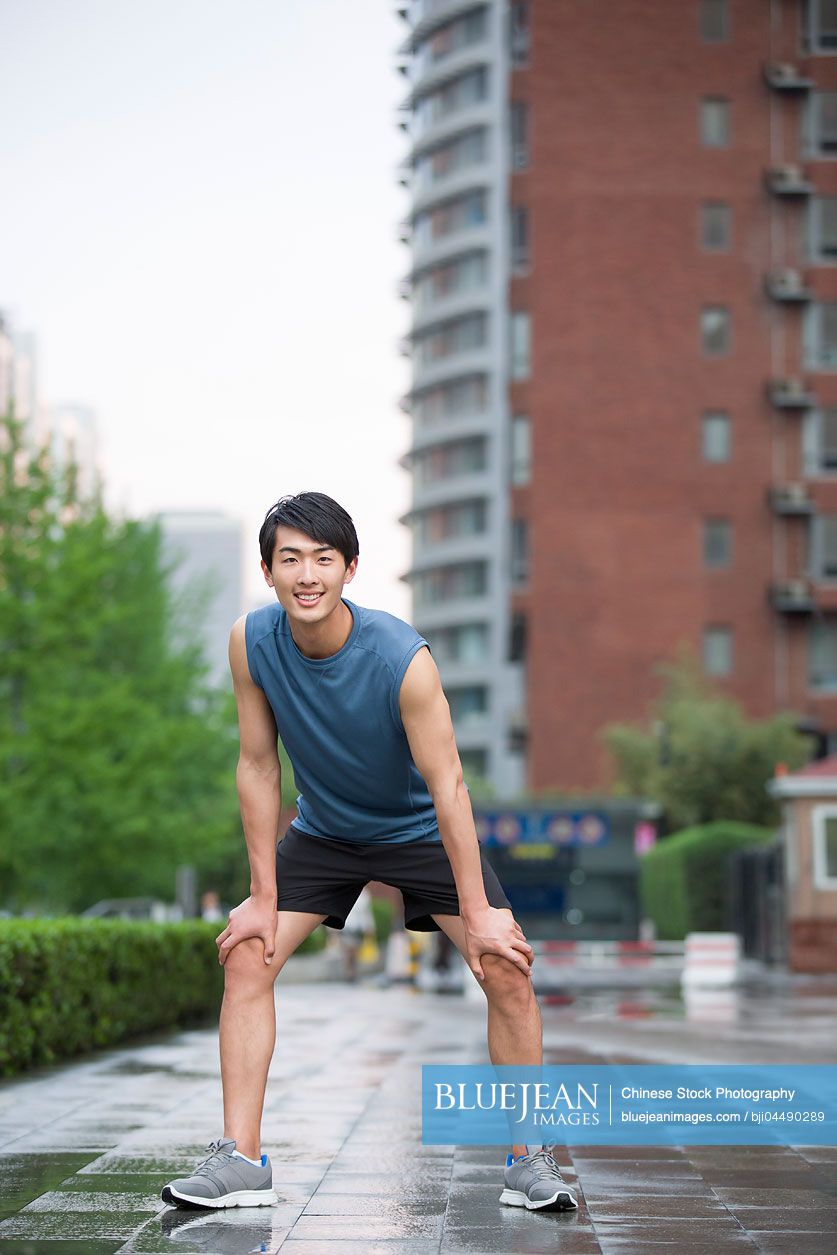 Young Chinese man taking a break from exercise