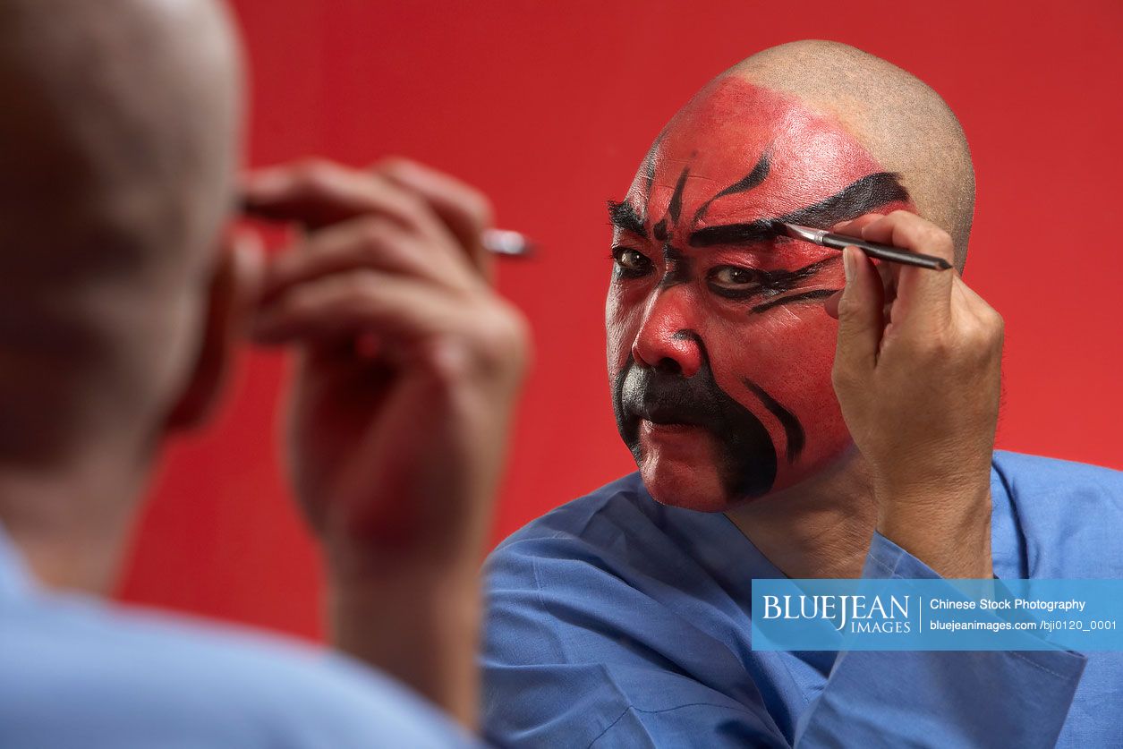 Chinese actor portraying Guang Dong, ancient Chinese general in  Beijing opera costume, represents protection and wealth