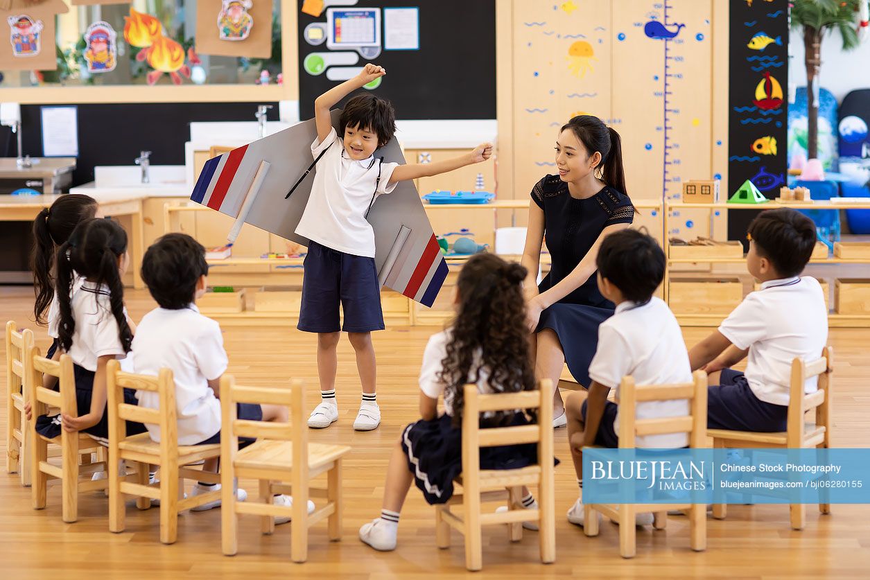 Chinese teacher and children in art class