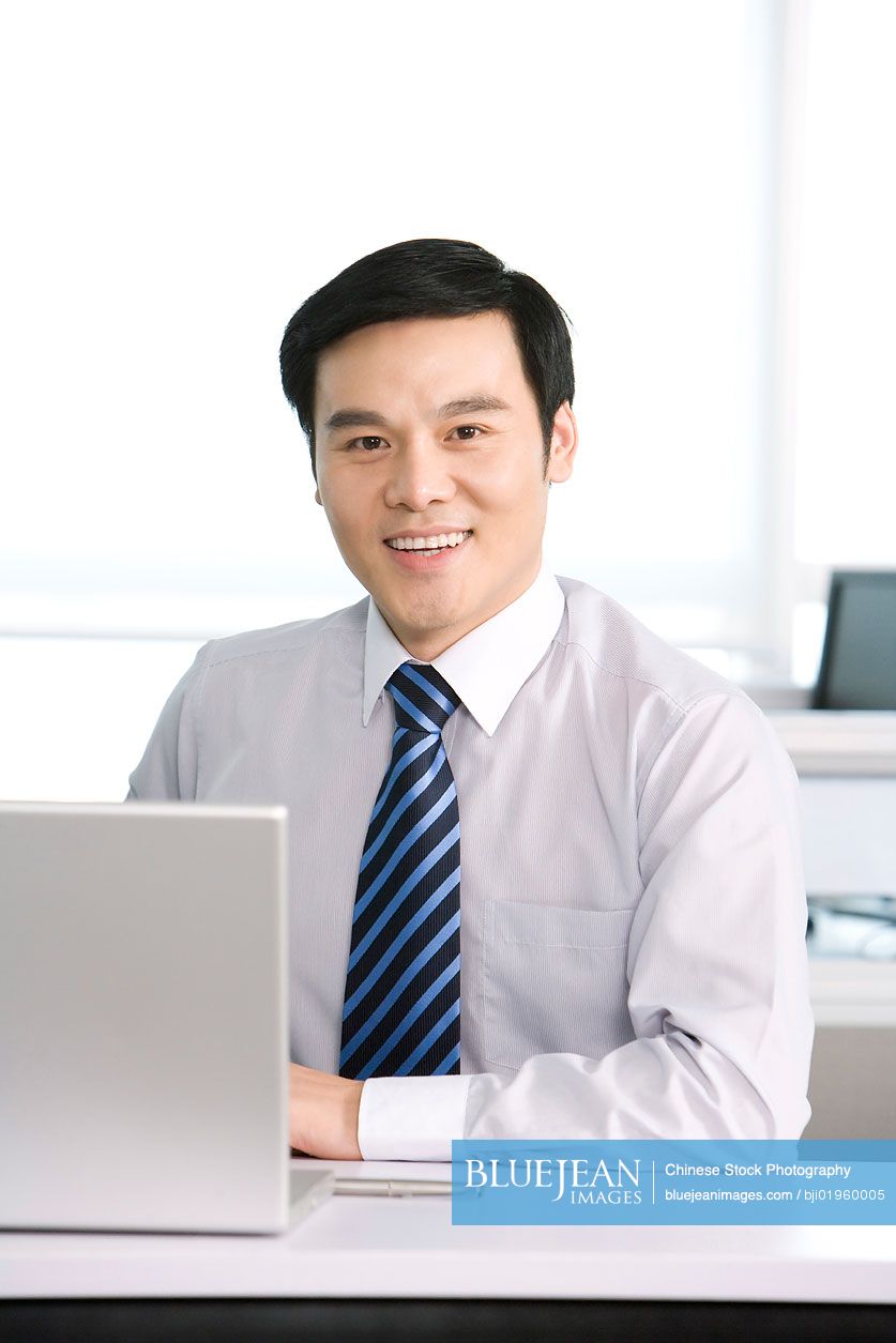 Chinese office worker at his desk
