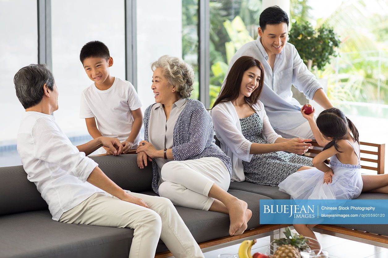 Happy Chinese family relaxing on the sofa